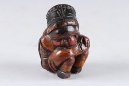 AN EARLY DUTCH WOODEN FIGURE OF A YOUNG BOY. 3ins high.