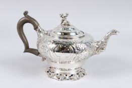 A GEORGE III SILVER TEAPOT, with embossed and chased body, the cover with Chinaman finial, bird head