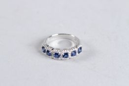 AN 18CT WHITE GOLD, SAPPHIRE AND DIAMOND SIX STONE RING.