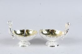 A PAIR OF SILVER PLATED CHERUB SALTS.