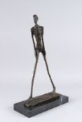 IN THE MANNER OF GIACOMETTI, A BRONZE ABSTRACT FIGURE OF A WALKING MAN, mounted on a rectangular