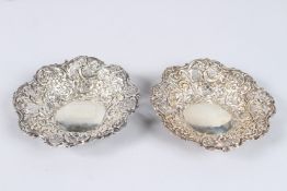 A PAIR OF SILVER BON BON DISHES, with embossed and pierced sides, Birmingham 1897, 6in diameter.