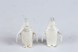 A SMALL PAIR OF SILVER PLATE PENGUIN SALT AND PEPPERS.