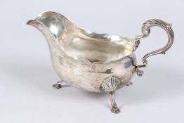 A GEORGE III SILVER SAUCE BOAT, with scroll handle on three hoof feet, London 1764, maker DS RS, 7.