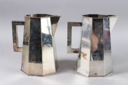 A PAIR OF SILVER PLATED OCTAGONAL JUGS 8ins high.
