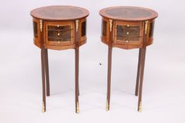 A PAIR OF FRENCH STYLE MARQUERTY AND ORMOLU THREE DRAWER OVAL BEDSIDE TABLES. 2ft 3ins high.