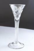 A JACOBITE WINE GLASS, the bowl engraved with roses. 6.5ins high.