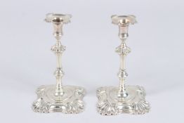 A PAIR OF CAST SILVER TAPER STICKS, of Georgian design, London 1937, makers John & Joseph Angel, 4.