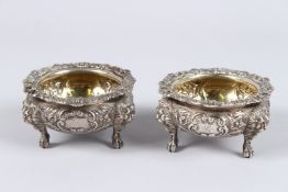 A GOOD PAIR OF SILVER SALTS, with shell cast borders and lion mask claw feet, London 1791, maker