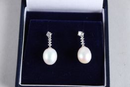 A PAIR OF 18CT WHITE GOLD, PEARL AND DIAMOND DROP EARRINGS.