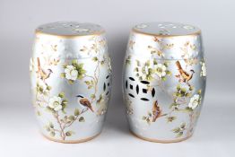 A PAIR OF CHINESE STYLE SILVERED PORCELAIN BARREL SEATS, decorated with flowers and birds, 18in