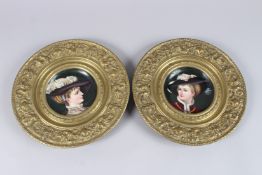 A PAIR OF LATE 19TH CENTURY CONTINENTAL CIRCULAR PORCELAIN PORTRAIT PLAQUES, of busts of a young man