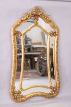 A LARGE DECORATIVE GILT FRAMED SECTIONAL MIRROR, with ribbon and bow cresting, 6ft 6in high x 3ft