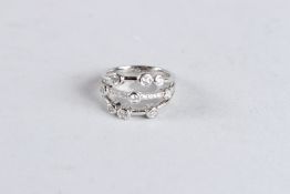 AN 18CT WHITE GOLD AND DIAMOND RAIN DROP RING.
