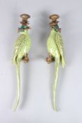 A PAIR OF PORCELAIN WALL SCONCES, modelled as green parrots on branches, 18.5in high.