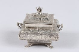 A CONTINENTAL SILVER BOX AND COVER, of bombe shape, the finial as a seated figure, scroll handles,