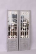 A PAIR OF GARDEN MIRRORS, with grey painted frames and wrought iron decoration, 4ft 11in high x