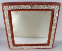 A LARGE VICTORIAN SILVER MOUNTED STRUTT MIRROR, with red velvet frame, the embossed mounts depicting