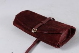 A VINTAGE CARTIER SUEDE AND LEATHER JEWELLERY ROLL.
