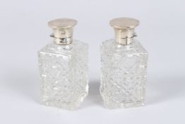 A PAIR OF SILVER TOP CUT GLASS SQUARE SHAPED PERFUME BOTTLES, Chester 1919, 4.5in high.