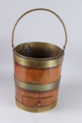A GEORGIAN MAHOGANY BUCKET with three brass bands and an iron handle. 14ins high.