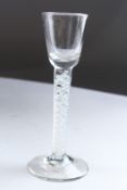 A GEORGIAN CORDIAL GLASS with white air twist stem. 6.5ins high.