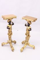 A PAIR OF DECORATIVE COMPOSITE GILTWOOD STYLE BLACKAMOOR STANDS with curving bases. 3ft high.