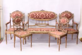 A FRENCH STYLE GILTWOOD AND UPHOLSTERED FIVE PIECE SALON SUITE, comprising of a two seater settee,