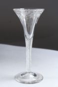 A GEORGIAN WINE GLASS engraved with fruiting vines, with air twist stem. 6.5ins high.