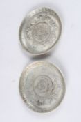 A PAIR OF CHINESE WHITE METAL COIN DISHES, 3¾in diameter.
