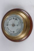 A A MAHOGANY BRASS MOUNTED CIRCULAR BAROMETER. Dial 6ins diameter.