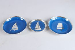 ALBOTH & KAISER A PAIR OF BLUE PORCELAIN SILVER RIMMED PLATES 13cm wide and another 9.5cm wide (3)