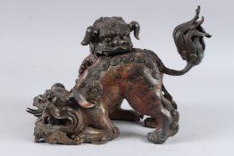 A CHINESE GILT BRONZE CENSOR, modelled as two temple lions, 12in long.