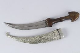A 19TH CENTURY OTTOMAN HORN HILTED DAGGER with silver scabbard. Blade 9ins long.