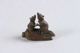 A SMALL BRONZE OKIMONO OF TWO RATS ON A CORN COB, 1½in long.