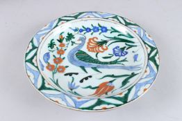 A 19TH CENTURY OTTOMAN TURKISH ISNIK PLATE decorated with a bird. 12ins diameter.