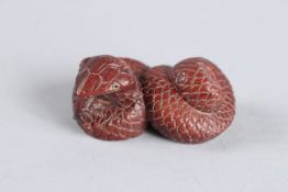 A HARDWOOD CARVED SNAKE NETSUKE. Signed. 2ins.