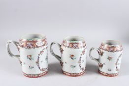 A GOOD GRADUATED SET OF THREE 19TH CENTURY CHINESE EXPORT PORCELAIN TANKARDS, with strap work