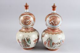 A PAIR OF 19TH/20TH CENTURY JAPANESE KUTANI PORCELAIN DOUBLE GOURD SHAPE VASES AND COVERS, painted