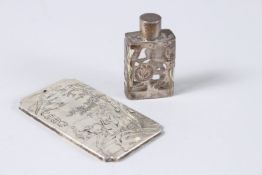 A CHINESE SILVER TABLET with figures and calligraphy, 4ins x 2.5ins, and a small scent bottle, 2.