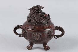 A CHINESE BRONZE CENSER with dragon lid and handles. 5ins high.