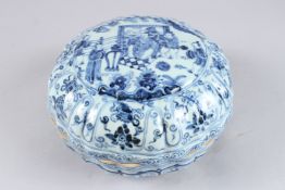 A CHINESE BLUE AND WHITE MOULDED CIRCULAR PORCELAIN BOX AND COVER, painted with figures in a
