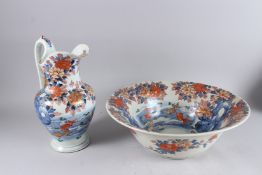 A JAPANESE IMARI PORCELAIN JUG AND BOWL, 20th century, painted with fish, flora and fauna, bowl 17½