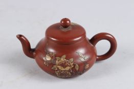 A SMALL CHINESE YIXING TEA POT with gilded calligraphy decoration. 5.5ins wide.