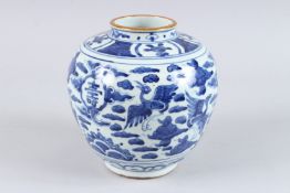 A CHINESE BLUE AND WHITE MING STYLE BULBOUS VASE decorated with flying storks. 7ins high.
