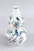 A CHINESE WUCAI DOUBLE GOURD VASE, painted with birds on a tree and butterflies, 9in high.
