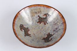 A CHINESE POTTERY BOWL decorated with goats. 6ins diameter.