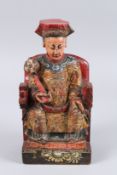 A CHINESE CARVED WOOD AND PAINTED FIGURE OF AN EMPEROR sitting on a throne. 11.5ins high.