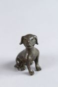 A BRONZE OKIMONO OF A SEATED DOG, 2½in high.