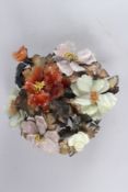 A CHINESE HARDSTONE FLOWER GROUP, comprising of various different carved hardstones, mounted on a